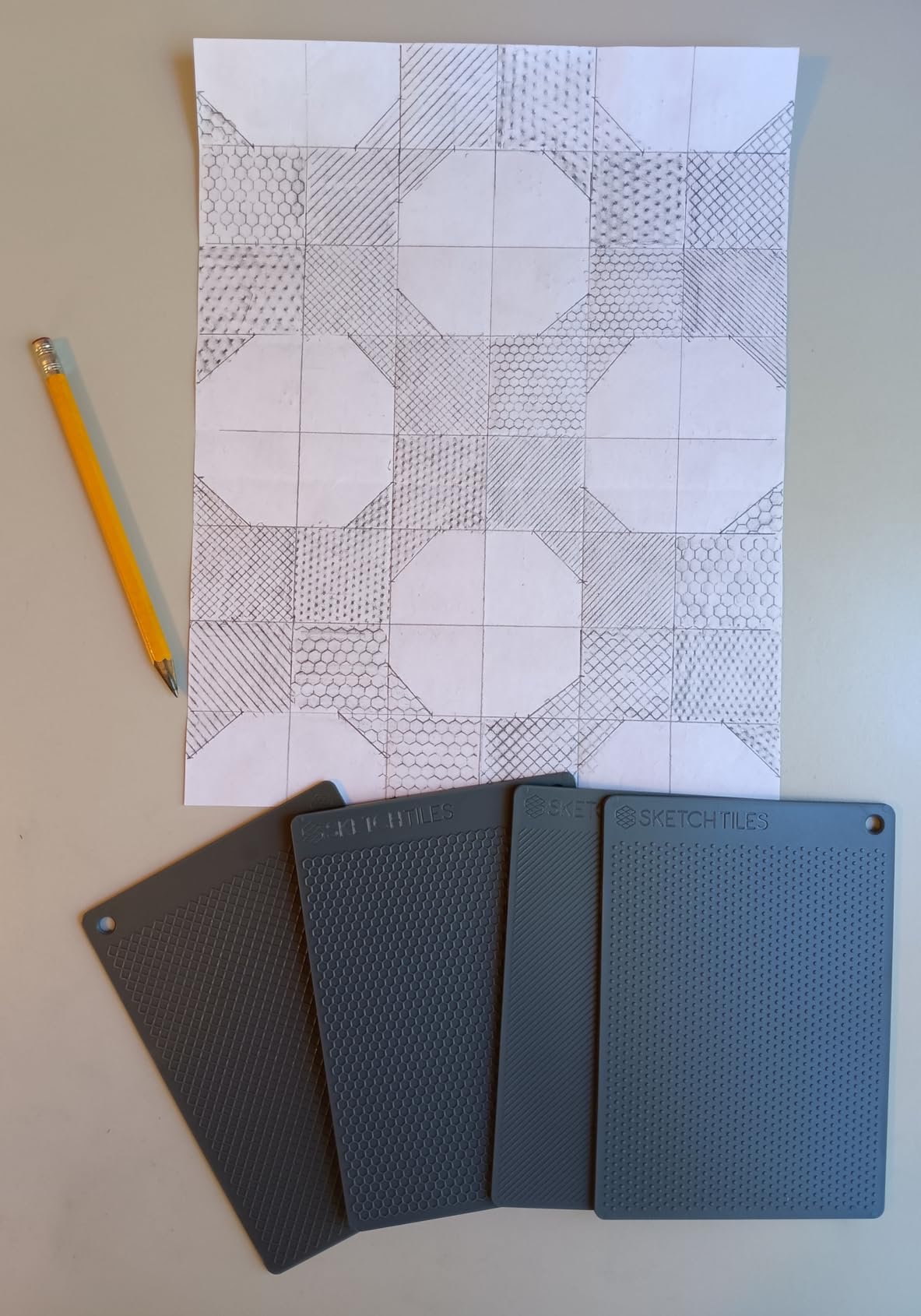 A pencil quilt design filled with several SketchTiles patterns.